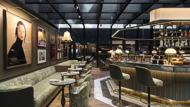 A bar area with seating, a bar counter, and a display of bottles. - Radisson Collection Hotel, Santa Sofia Milan (Milan)