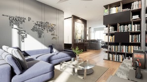 Un salon moderne avec un canapé d’angle, une table basse et une bibliothèque remplie de livres.