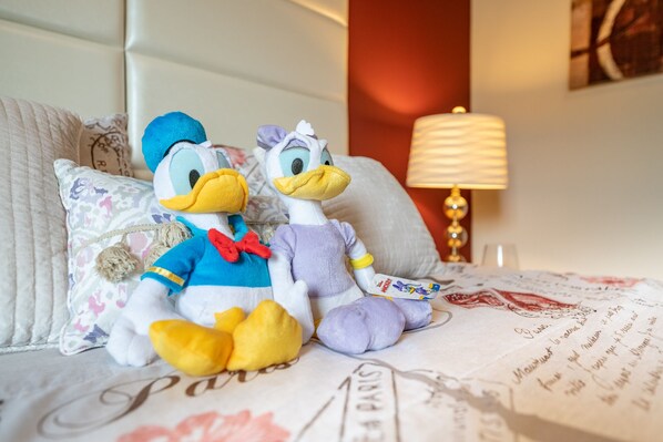 Two plush toys on a bed with a map of Paris.