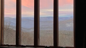 A window with a view of a mountainous landscape.