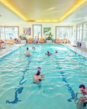 Relax by the pool, surrounded by lush greenery and comfortable lounge seating.