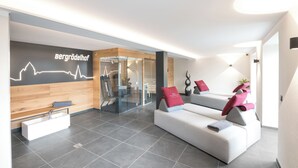 A modern reception area with a reception desk, a seating area with sofas, and a wall with a line graph.