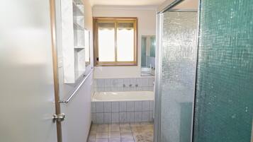 Bathtub, hair dryer, towels, soap