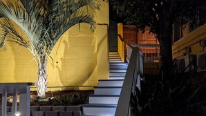 A staircase with white steps leading up to a wooden deck.