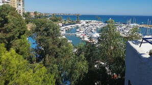 A marina with boats, a clear blue sky, and buildings in the background. - Holiday Apartment "Sunnygolfbeach" with Shared Pool, Terraces & Wi-Fi (Orihuela Costa)