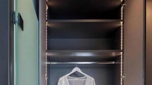 A walk-in closet with a hanging rack, drawers, and a small speaker. - Villa "Desun Suites Grey" with Sea View, Pool & Wi-Fi (Leukada)