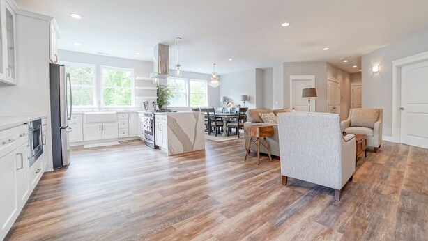 A spacious kitchen with white cabinetry, a central island, and a dining area with a chandelier. - Beautiful Valley Farm House, With View (Puyallup)