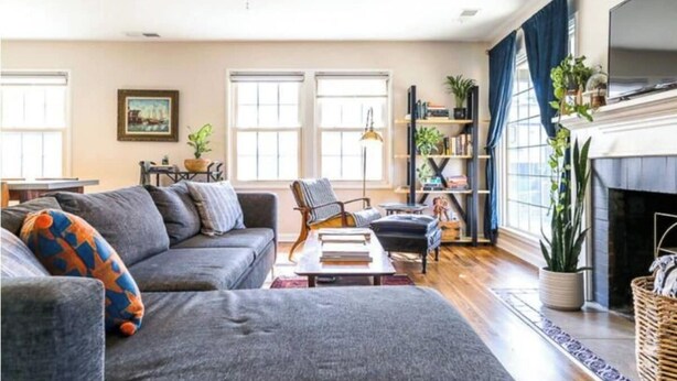 A living room with a sofa, armchairs, a fireplace, and a bookshelf. - Chic Boho Getaway Near Downtown Visalia (Visalia)