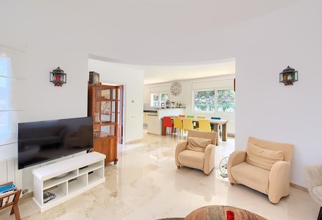 A modern living room with a TV, sofa, and coffee table.. Villa "with Pool Ac and Sea View" with Pool, Garden & Wi-Fi