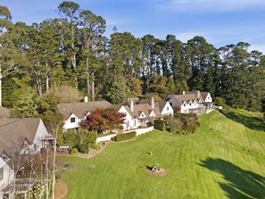 Traditional homes set amidst lush green lawns and mature trees, offering a serene and environment.
