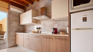 A kitchen with wooden cabinets, a microwave, and a refrigerator.