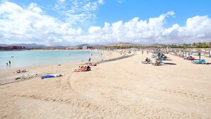 A beach with clear skies, a sandy shore, and a few people. - Holiday Apartment "Paulalucía" with Mountain View, Shared Pool & Wi-Fi (Costa de Antigua)