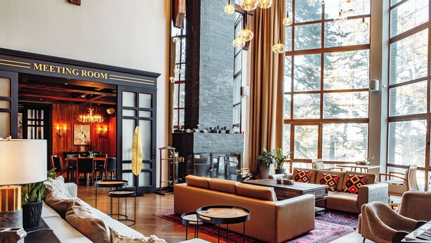 A spacious meeting room with a fireplace, large windows, and modern furnishings. - Dom u ozera  (Burabay)