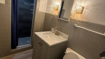 Shower, rainfall showerhead, hair dryer, towels