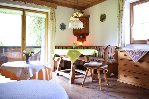 A wooden dining area with a table, chairs, and a bench.