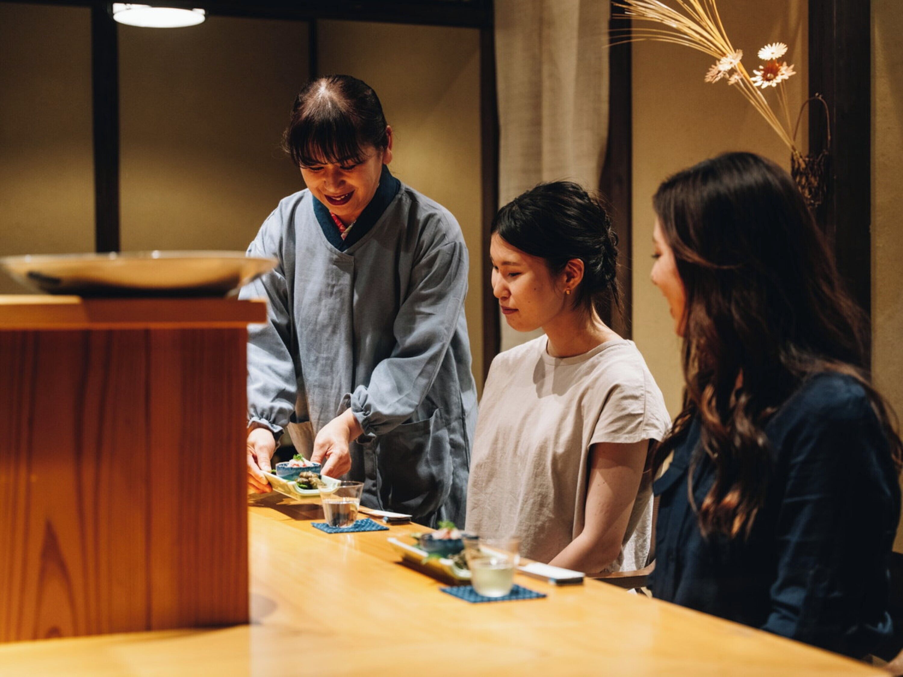A traditional Japanese restaurant with a wooden table set for a meal.