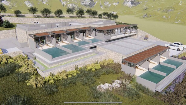 Un complexe hôtelier moderne doté de plusieurs piscines, d’espaces de détente en plein air et offrant une vue imprenable sur les montagnes.