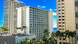 Ein Hotel mit mehreren Stockwerken, einem Poolbereich und Blick aufs Meer.