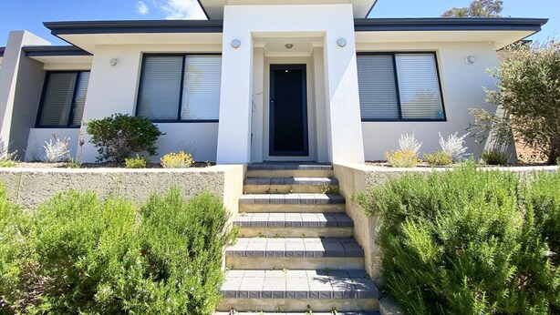 A modern two-story house with a flat roof, a central entrance with steps, and a small front garden. - Modern 4X2 Perth house near Stadium/Casino/Airport (Cloverdale)