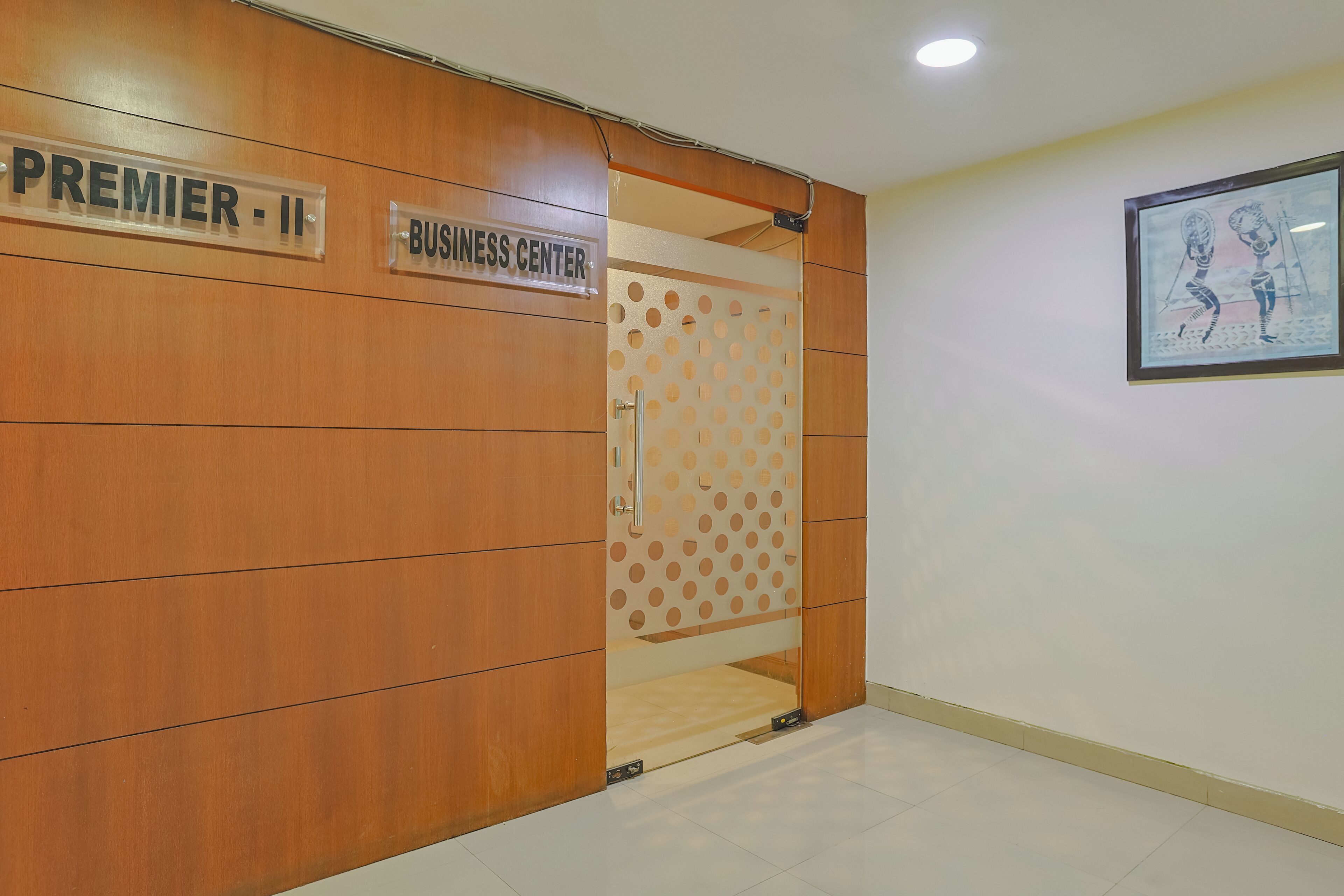 A wooden wall with signs for "Premier II" and "Business Center".