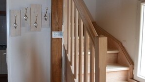A staircase with wooden railings and a wall-mounted light fixture. - Air-conditioned, garden, private heated pool, pets welcome.  (Eyraud-Crempse-Maurens)