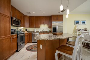 Enjoy cooking in this well-equipped kitchen with a sink, range, and refrigerator.