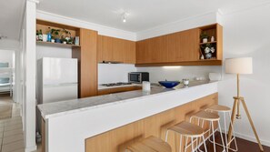 Enjoy cooking in this kitchen with a microwave and stove on the island, along with a convenient stool bar.