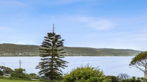 Escape to a serene coastal haven with breathtaking views of the sea and surrounding hills.