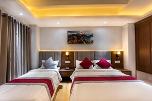 A hotel room with two beds, a painting on the wall, and a ceiling light. - Hotel Ama-La, The Heart of Comfort in Thamel (Kathmandu)