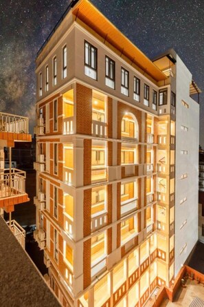 A multi-story hotel with a modern design, featuring balconies and large windows. - Hotel Ama-La, The Heart of Comfort in Thamel (Kathmandu)