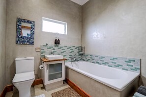 Bathtub, hair dryer, soap, shampoo