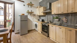A compact kitchen with wooden cabinets, a built-in oven, a microwave, and a sink. - Casa Borsa con Balcone by Wonderful Italy (Palermo)