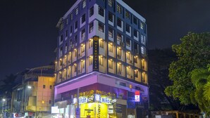 A multi-story hotel with illuminated signage, balconies, and a prominent 'METROPOLIS' sign. - Metropolis Business Hotel (Panaji)