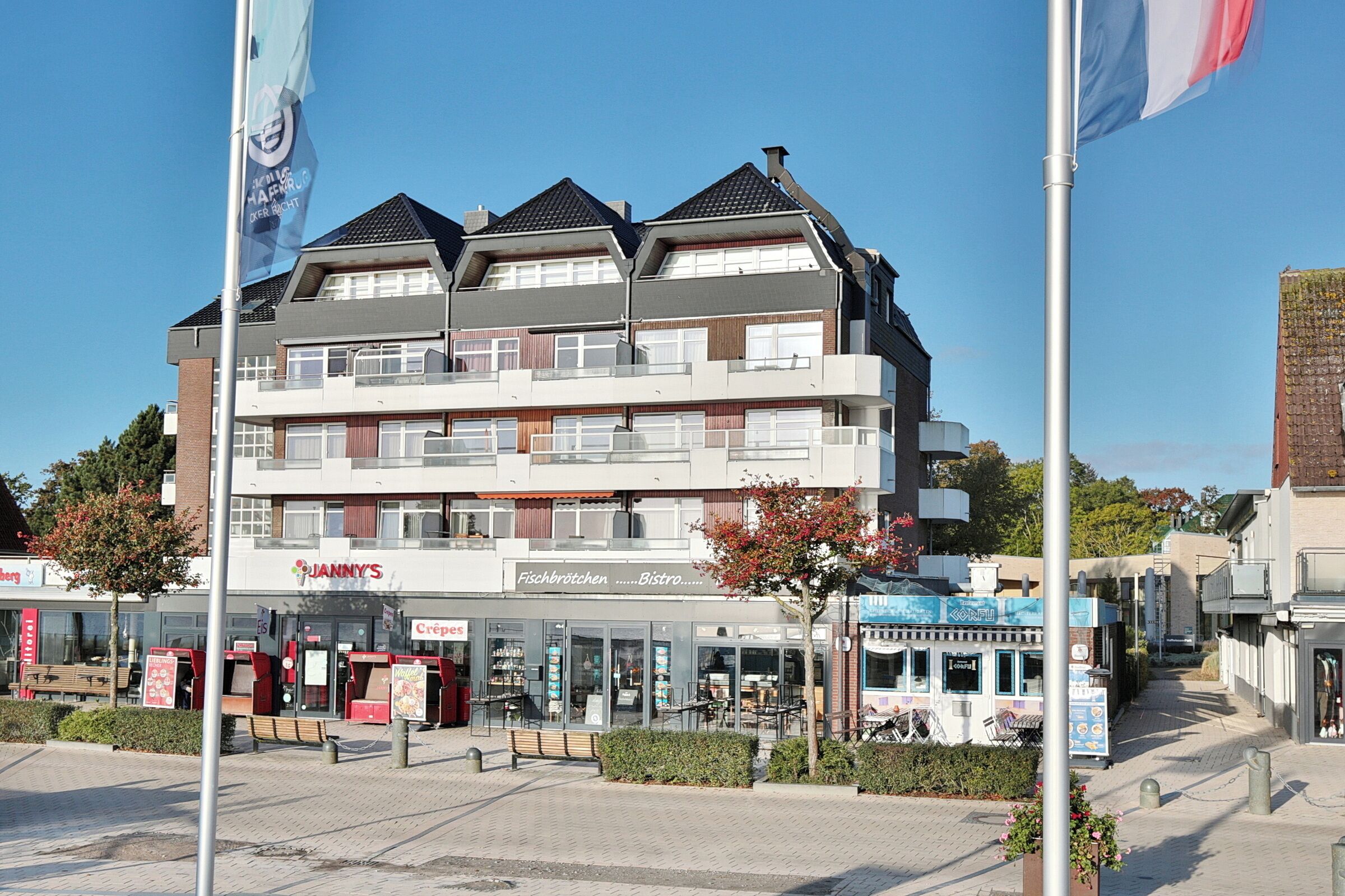 A multi-story building with a restaurant named "Janny's" on the ground floor.