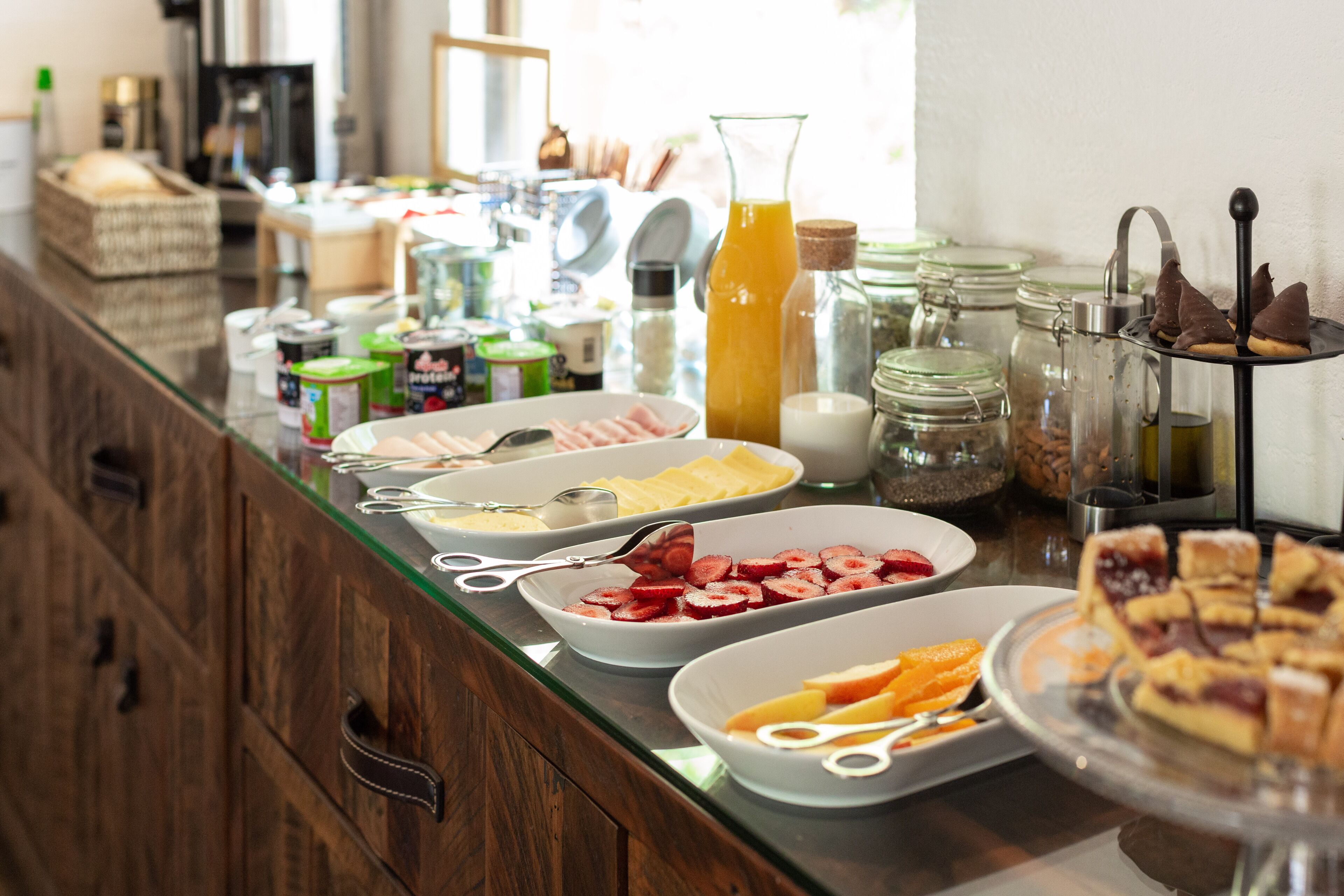 A buffet with various food items and condiments.