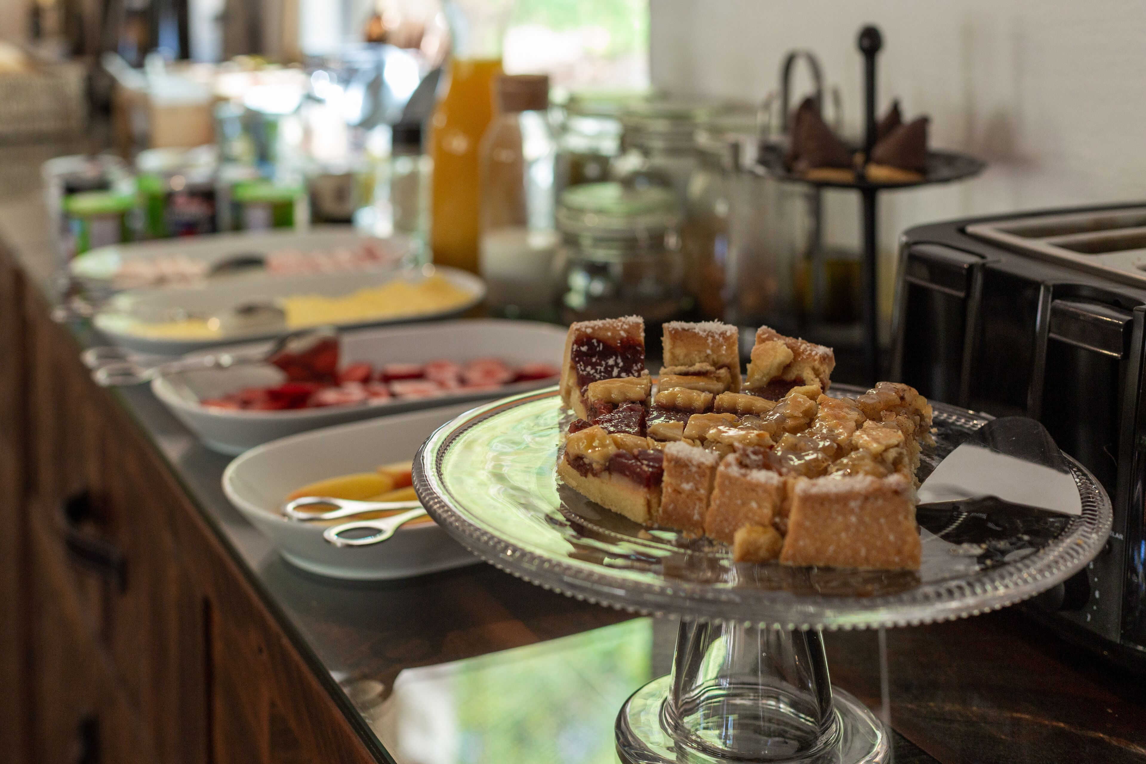 Un buffet proposant une variété de plats présentés dans des plats de service en verre.