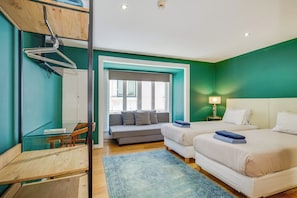 A modern bedroom with a sofa, two beds, a desk, and a mirror. - Bairro Alto | 4 Bedrooms + 4 Baths | Sleeps 8 (Lisboa)