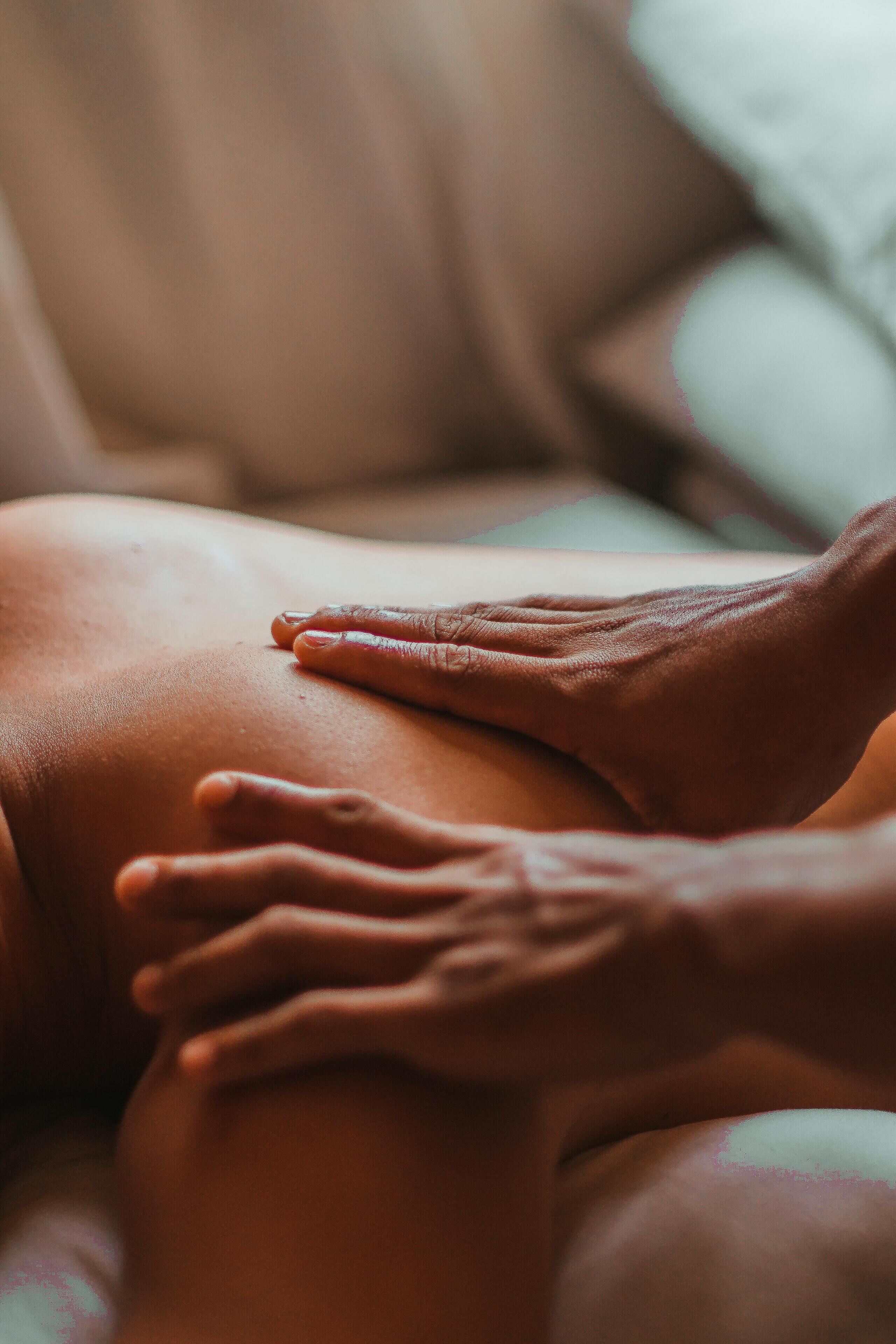 A close-up of a hand resting on a person's knee.