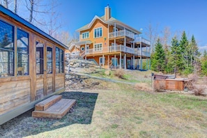 A large wooden house with multiple balconies and a deck area.