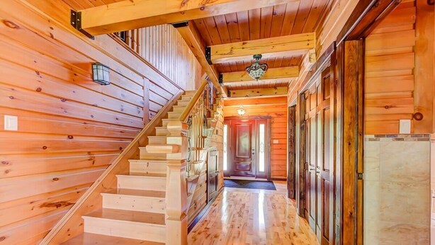 A wooden interior with a staircase leading to a door. - Grandes-Piles | Spa, dock, navigable river & ski (Grandes-Piles)