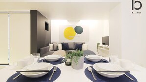 A modern hotel room with a dining area set for four, featuring a minimalist design with a neutral color palette. - b hotel 102 Central Inner-Side Comfort Studio (Hiroshima City)