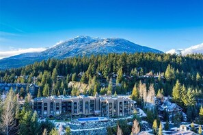Surrounded by evergreen trees and a snow-capped mountain, this resort offers serene views.