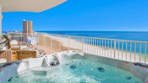 A balcony with a hot tub, wicker furniture, and a view of the beach and ocean. - Turquoise Place C1501 | Gorgeous Updates! Oversized, hot tub/grill on deck, huge slide for kids! (Orange Beach)