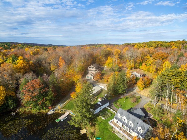 A residential area with multiple houses surrounded by autumn foliage.