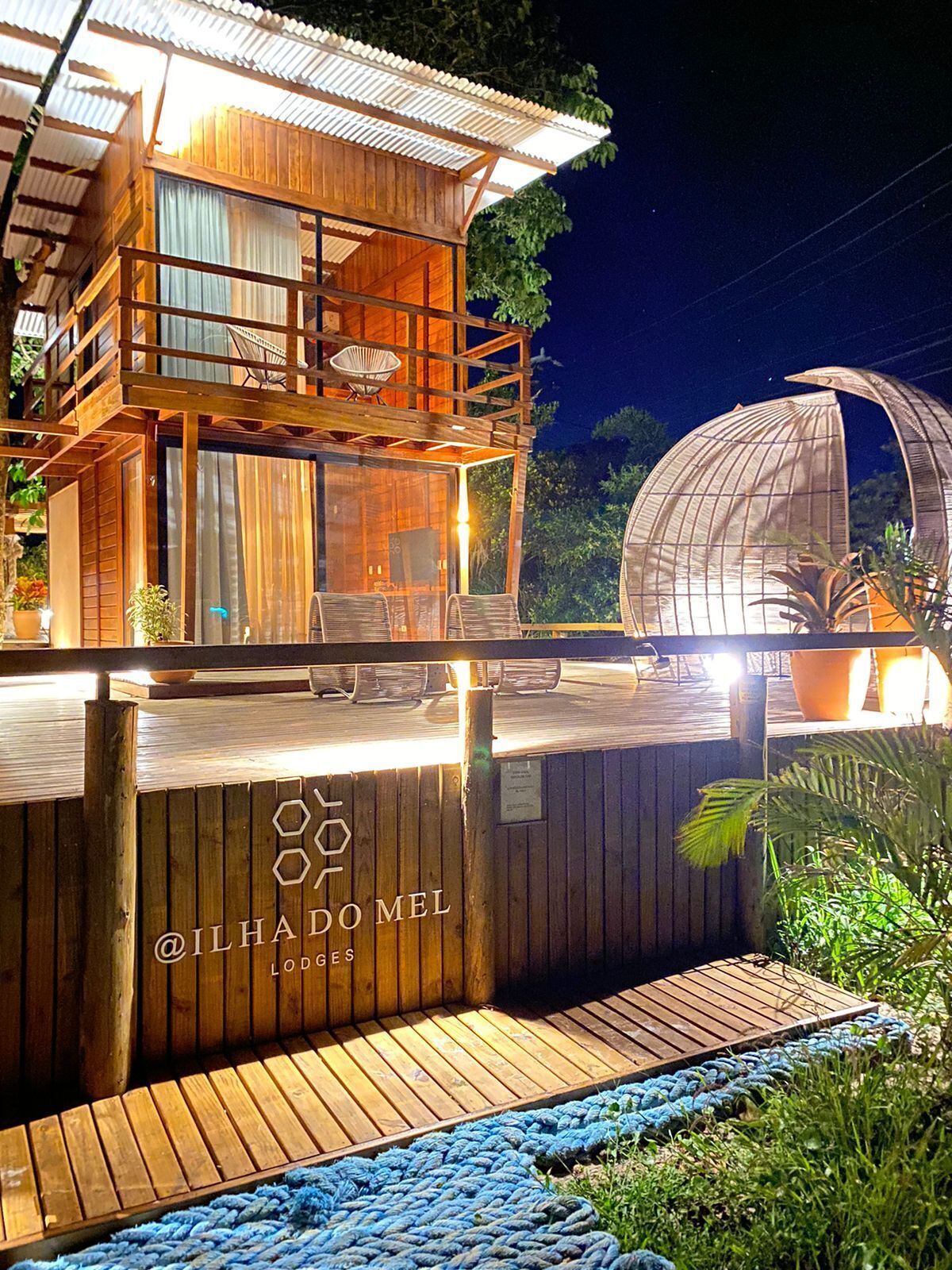 A wooden cabin with a balcony and a glass dome structure.