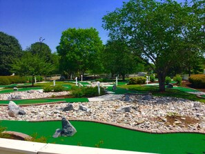 A miniature golf course with multiple holes, green artificial turf, and scattered rocks. - WOW! 4BDR family townhouse unit at Historic Hilton Powhatan Resort. Near Busch. (Williamsburg)