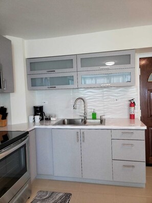 Fridge, microwave, stovetop, coffee/tea maker