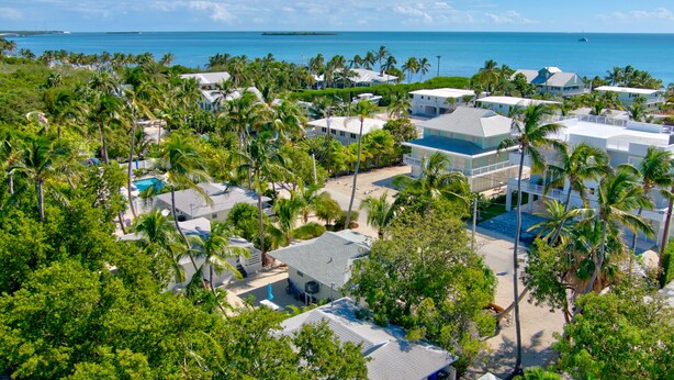 A resort with multiple buildings, palm trees, and a view of the ocean. -  Bungalow #3 - 2 Bed/1 Bath & Pool in Islamorada (Islamorada)