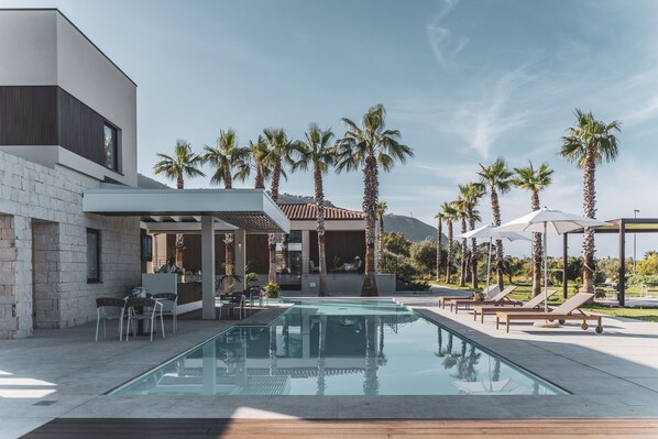 Outdoor pool, open 9:00 AM to 7:30 PM, pool loungers