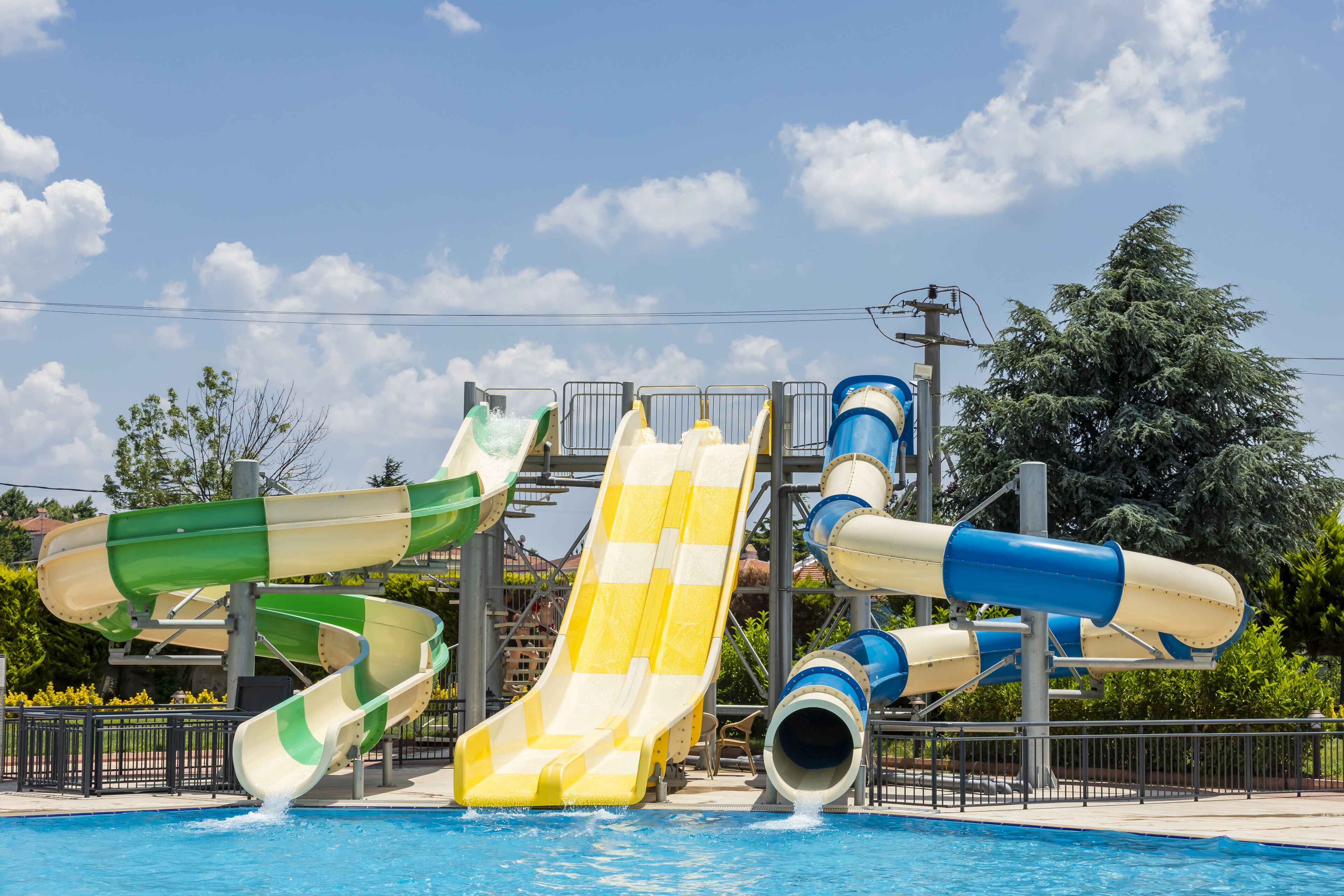 Parque acuático con múltiples toboganes y una piscina.